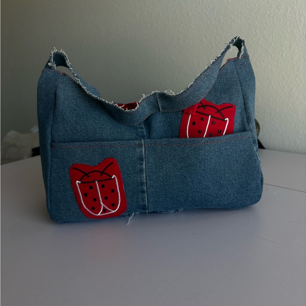 Stylish Denim Shoulder Bag with Red Accents